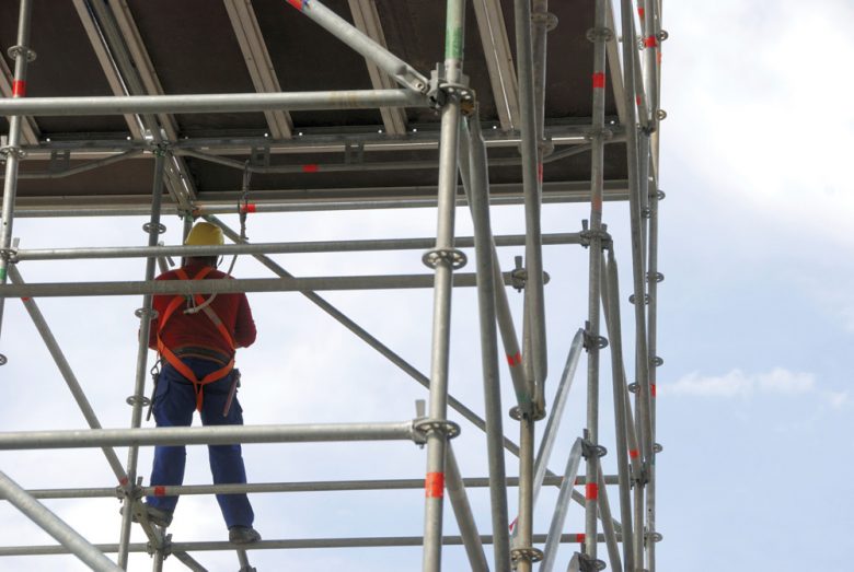 Worker in full PPE on scaffolding