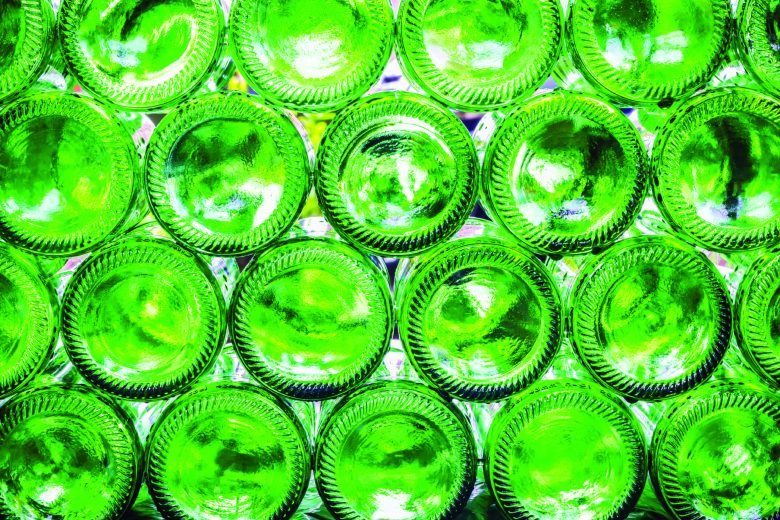 Green bottles stacked sideways in a Heineken plant