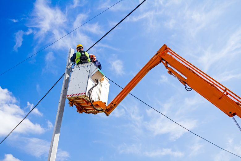 Power line team at work on a pole