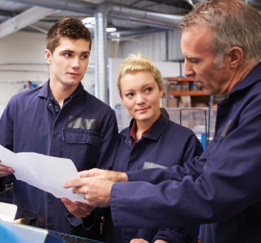 Workers discussing a document