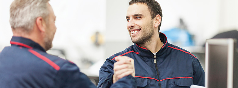 Industrial workers happily shaking hands