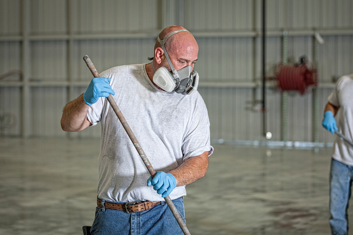 Man Wears a Protective Face Mask While Painting