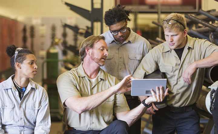 Instuctor and students in technical training school