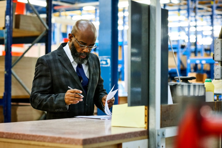 African businessman working in warehouse