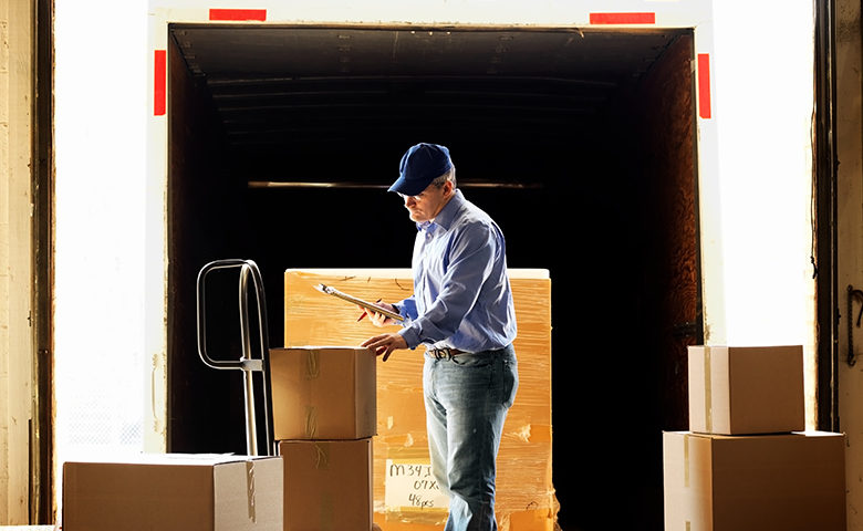 Worker processing shipment on loading dock