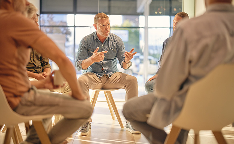 Group sitting around listening to a story