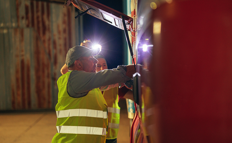 Two workers performing a safety check in the dark
