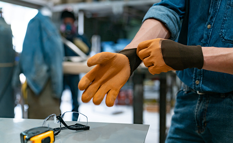 Putting on safety gloves before work