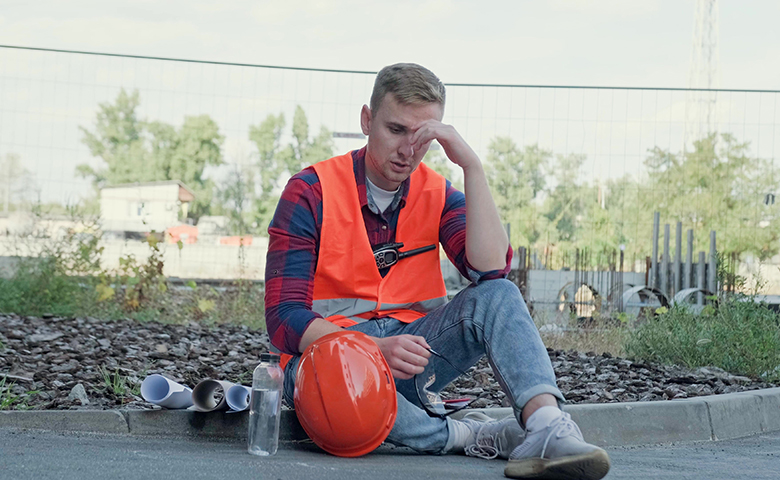 Worker suffering from fatigue on break